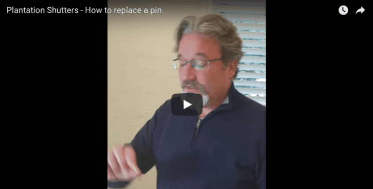 Man demonstrating how to replace a pin in plantation shutters for easy maintenance.