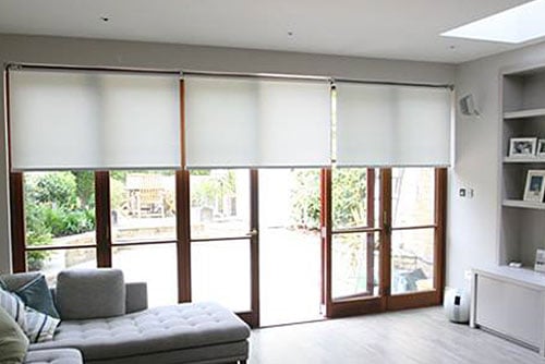Internal blinds installed on large window and door openings.