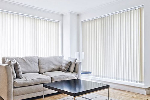 Internal blinds in a bright, minimalist living room with large windows. Perfect for controlling ligh.