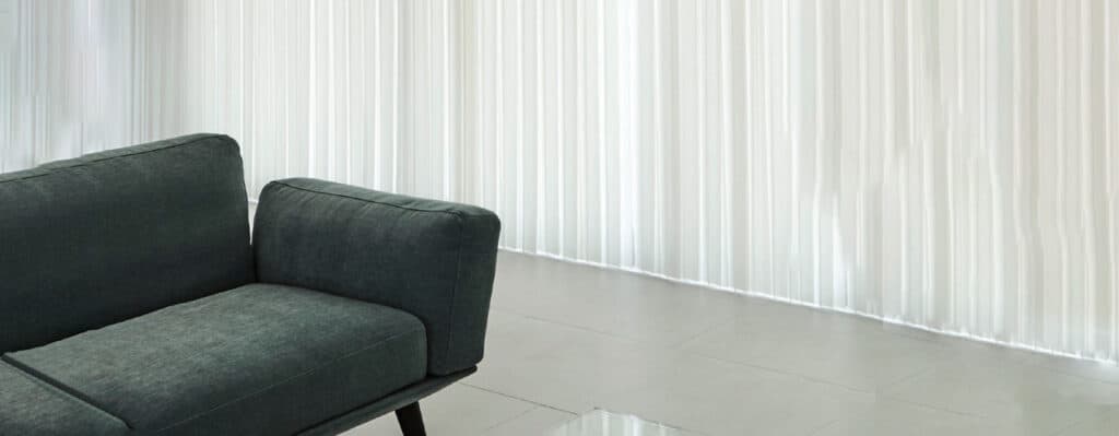 Modern Verishades window coverings in a bright room with white curtains.