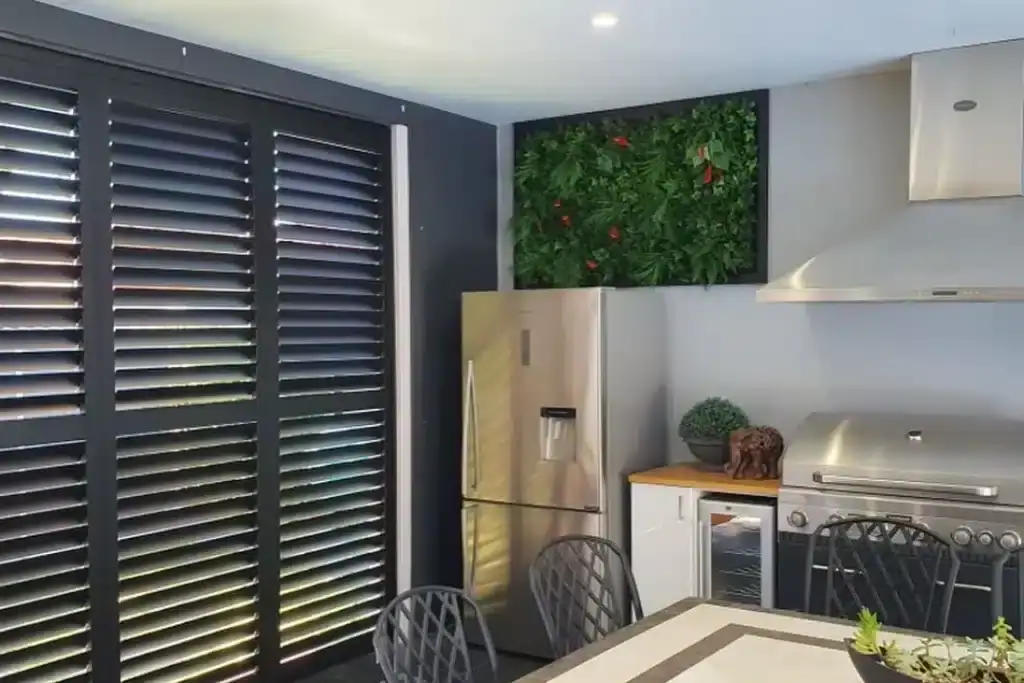 Elegant black plantation shutters in modern kitchen.